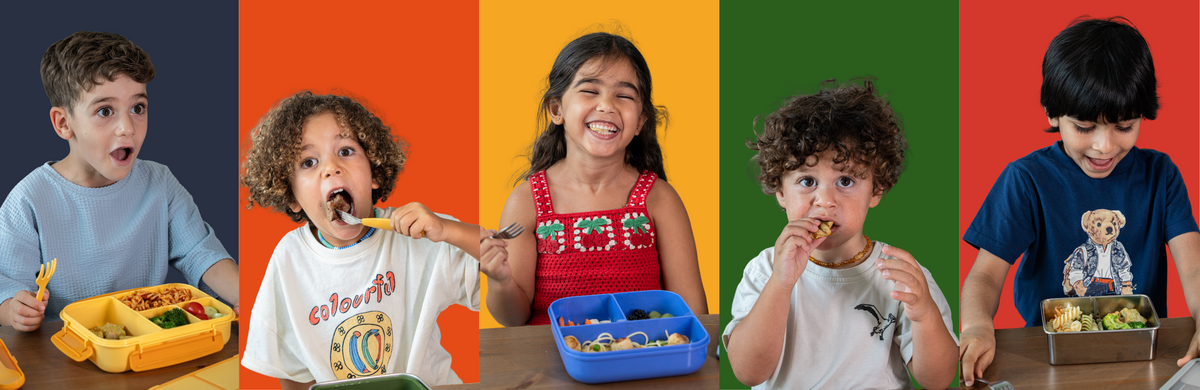 A horizontal banner featuring five children of different ethnicities eating colorful lunch boxes in front of vertical panels of navy, orange, yellow, green, and red, set on a beige background.